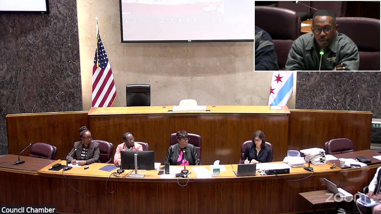 Ald. Walter R. Burnett (27th Ward), shown in an inset, speaks about the Suder Montessori playground at the Committee on Finance as members sit at the dais, Oct. 5, 2026